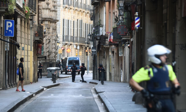 Police secure the area close to the scene after a white van jumped the sidewalk in the historic Las Ramblas district of Barcelona, Spain, crashing into a summer crowd of residents and tourists Thursday, Aug. 17, 2017. According to witnesses the white van swerved from side to side as it plowed into tourists and residents. (AP Photo/Giannis Papanikos)